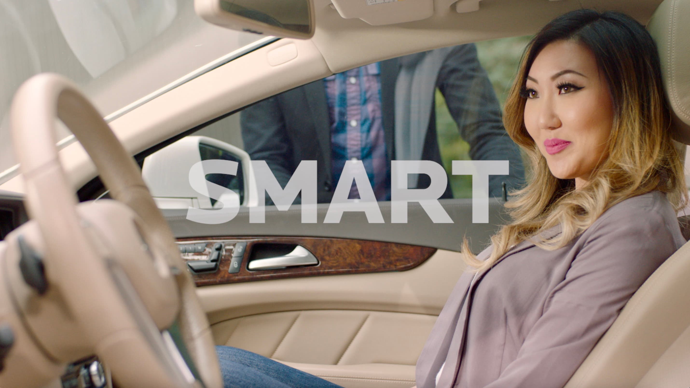 Screenshot of a woman sitting in a vehicle