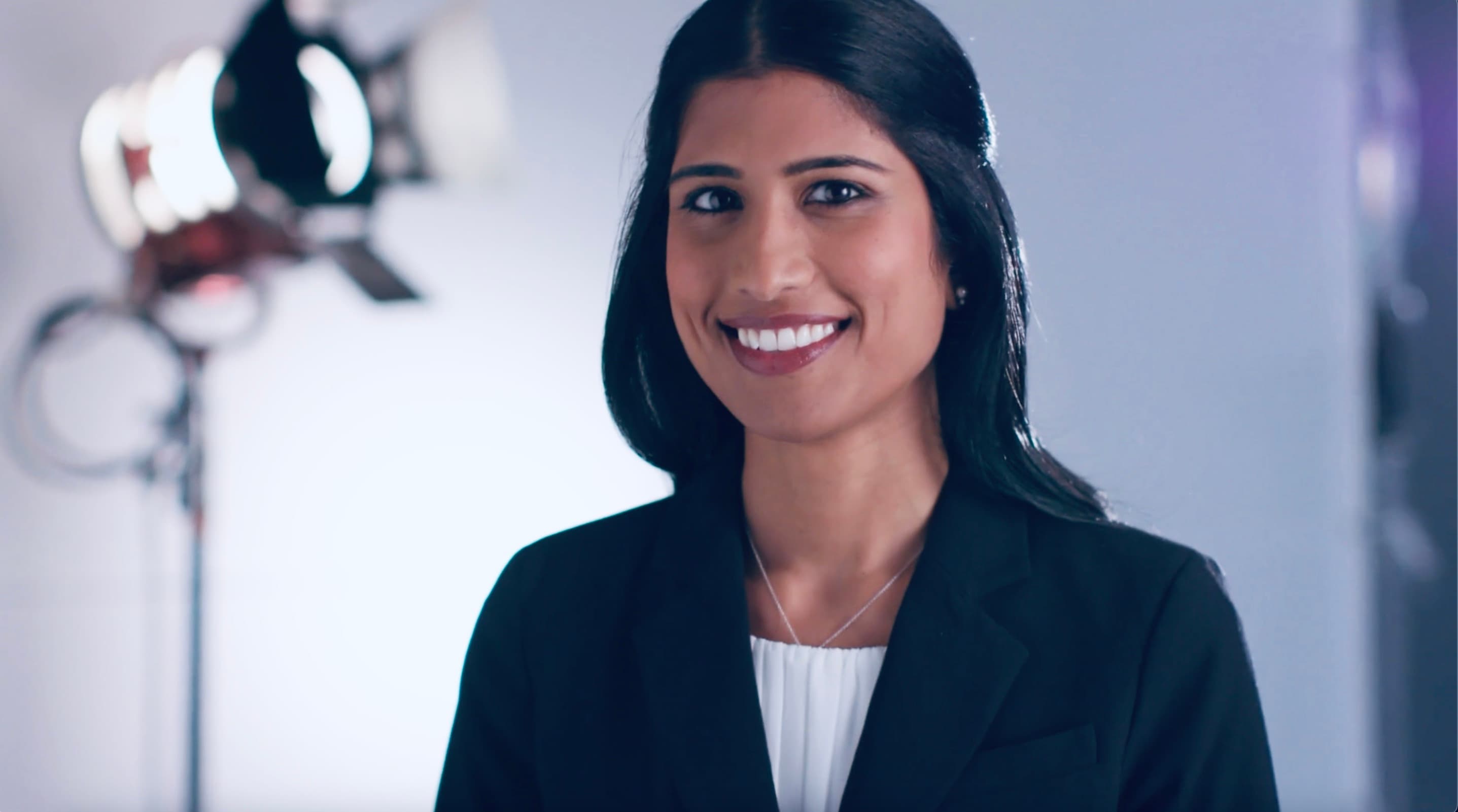 Screenshot of doctor smiling as she discusses her research